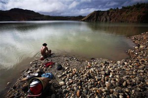 A hand-picker washes himself after searching for jade through rubble dumped by mining companies at a jade mine in Hpakant township, Kachin State